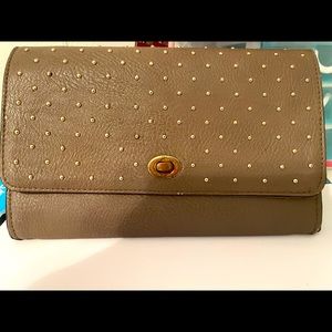 A brown wallet with gold prices
